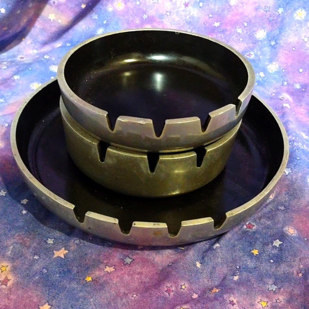 Set of three metal and enamel ashtrays